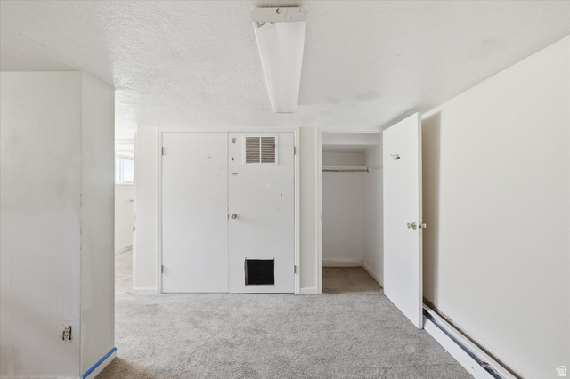395 North 400 West Logan, UT 84321 - Photo 21 of 48 White painted walls, textured ceiling, and gray carpeted flooring