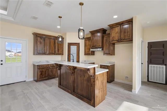 a kitchen with a sink refrigerator and cabinets