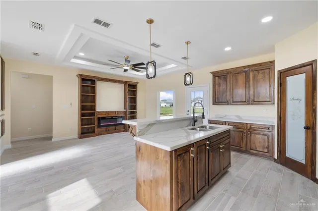 a kitchen with kitchen island a sink counter top space and stainless steel appliances