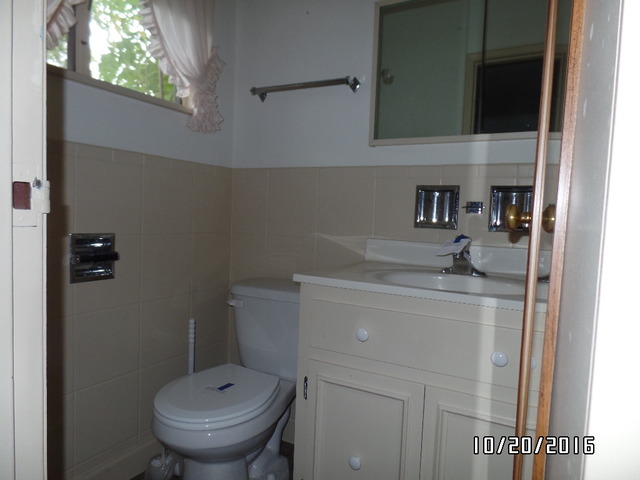 276 Rich Road Park Forest, IL 60466 - Photo 16 of 18 a bathroom with a toilet sink and mirror
