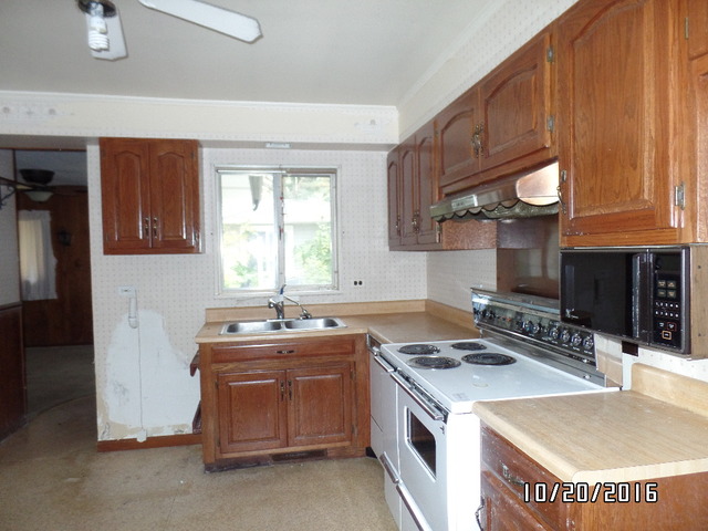 276 Rich Road Park Forest, IL 60466 - Photo 5 of 18 a kitchen with a sink stove and cabinets