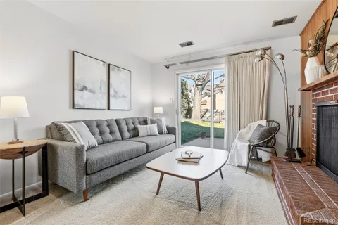 a living room with furniture a fireplace and a table