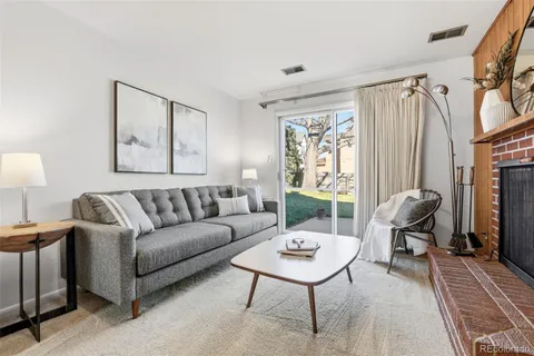 a living room with furniture a fireplace and a table