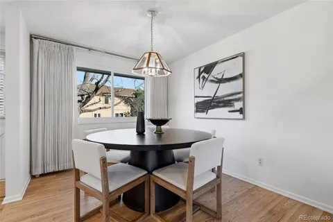 a view of a dining room with furniture wooden floor and chandelier
