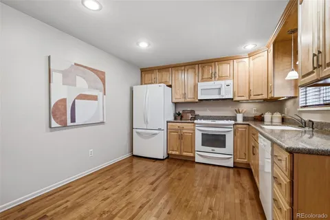 a kitchen with a white cabinets and white appliances