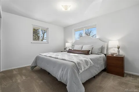 a bedroom with a bed and lamp