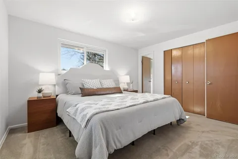 a bedroom with a bed and a painting