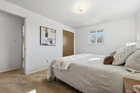 a bedroom with a bed and wall painting