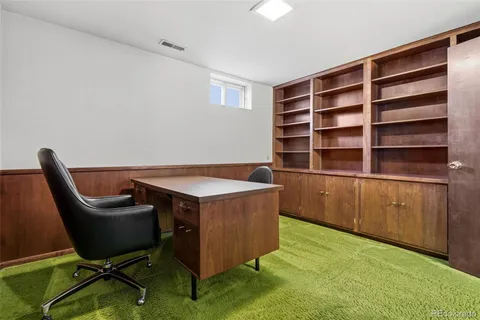 a bathroom with a granite countertop toilet sink and mirror