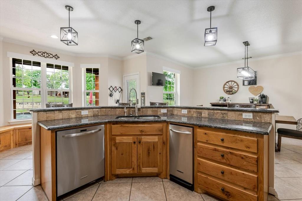 318 East Lone Star Road Poolville, TX 76487 - Photo 21 of 33 a kitchen with a sink stove and window