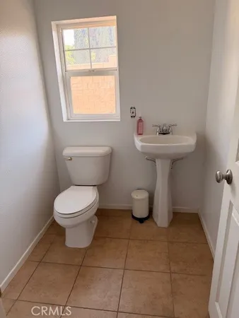 a bathroom with a sink toilet and mirror