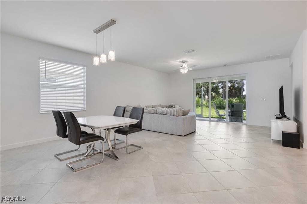 9146 Leatherwood Loop Lehigh Acres, FL 33936 - Photo 12 of 43 a living room with furniture and a large window