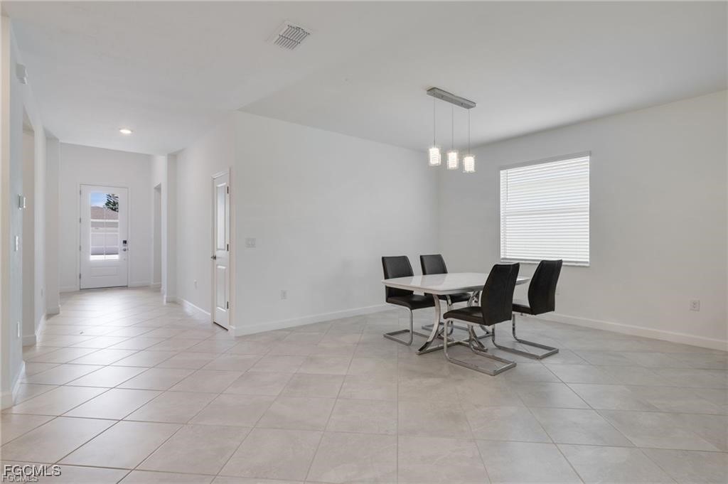 9146 Leatherwood Loop Lehigh Acres, FL 33936 - Photo 13 of 43 a workspace with furniture and a ceiling fan