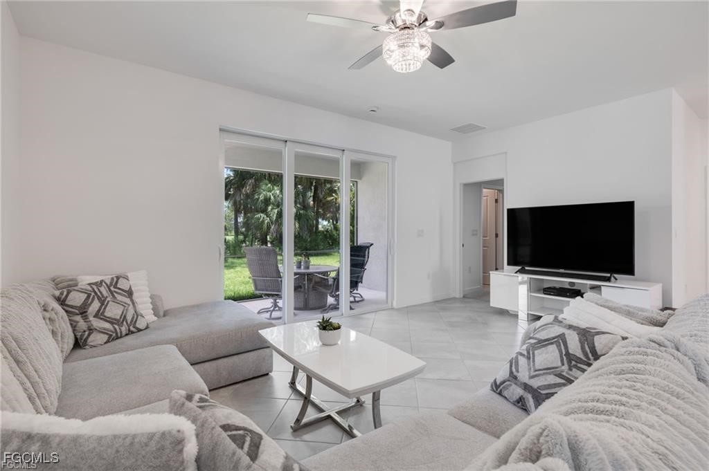 9146 Leatherwood Loop Lehigh Acres, FL 33936 - Photo 15 of 43 a living room with furniture and a flat screen tv