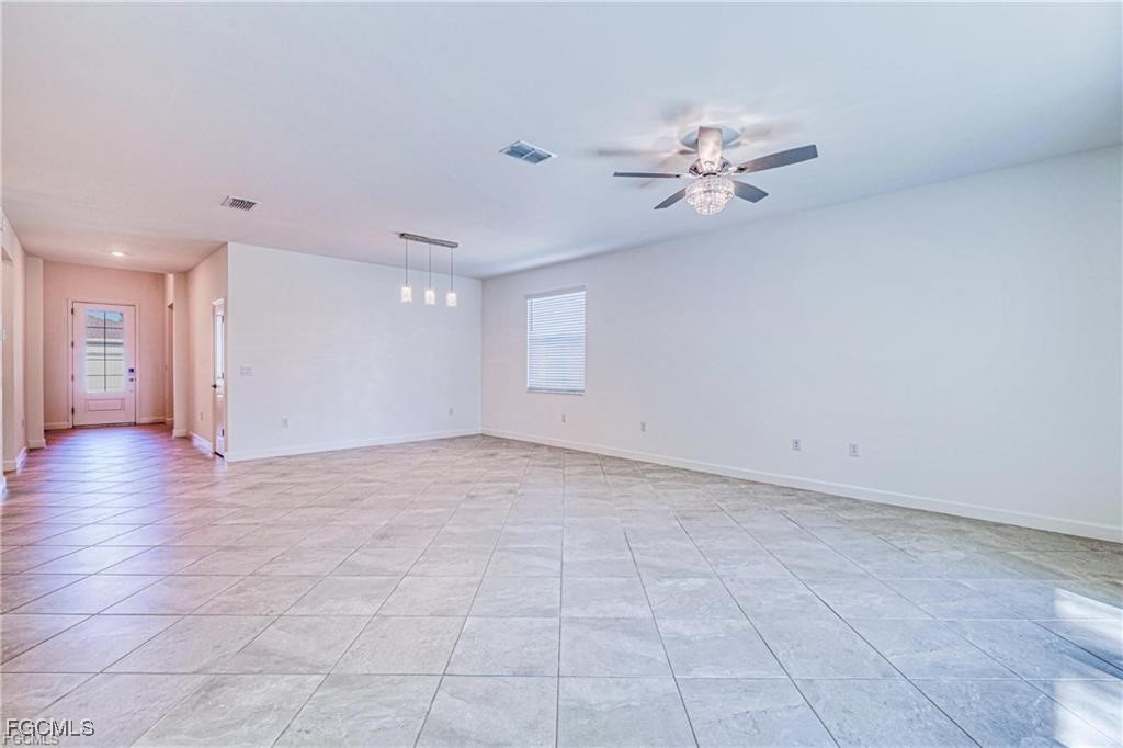 9146 Leatherwood Loop Lehigh Acres, FL 33936 - Photo 16 of 43 a view of a livingroom with a ceiling fan and window
