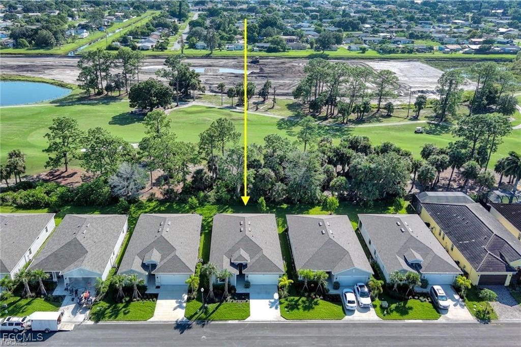 9146 Leatherwood Loop Lehigh Acres, FL 33936 - Photo 2 of 43 an aerial view of a house with a garden and lake view