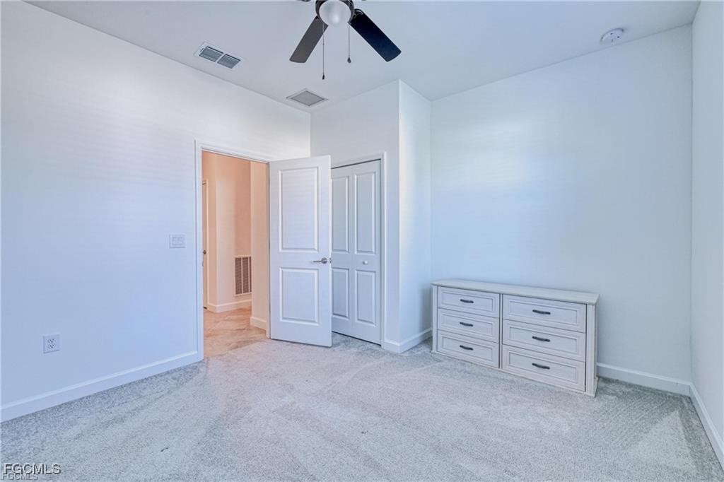 9146 Leatherwood Loop Lehigh Acres, FL 33936 - Photo 28 of 43 an empty room with windows