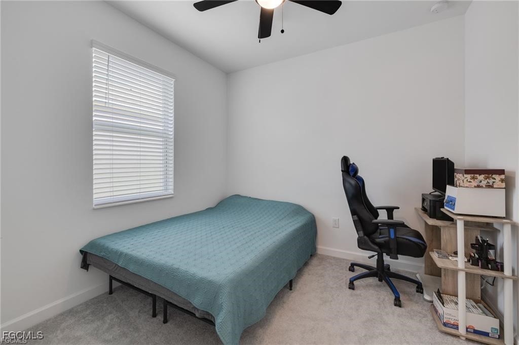 9146 Leatherwood Loop Lehigh Acres, FL 33936 - Photo 29 of 43 a bedroom with a bed and a desk