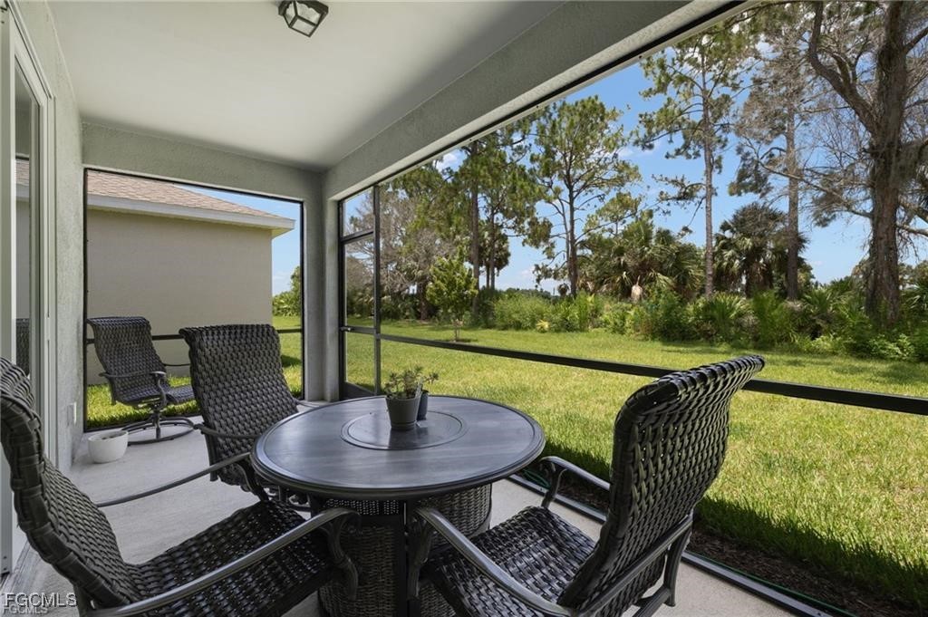 9146 Leatherwood Loop Lehigh Acres, FL 33936 - Photo 34 of 43 a view of a chairs and table in patio