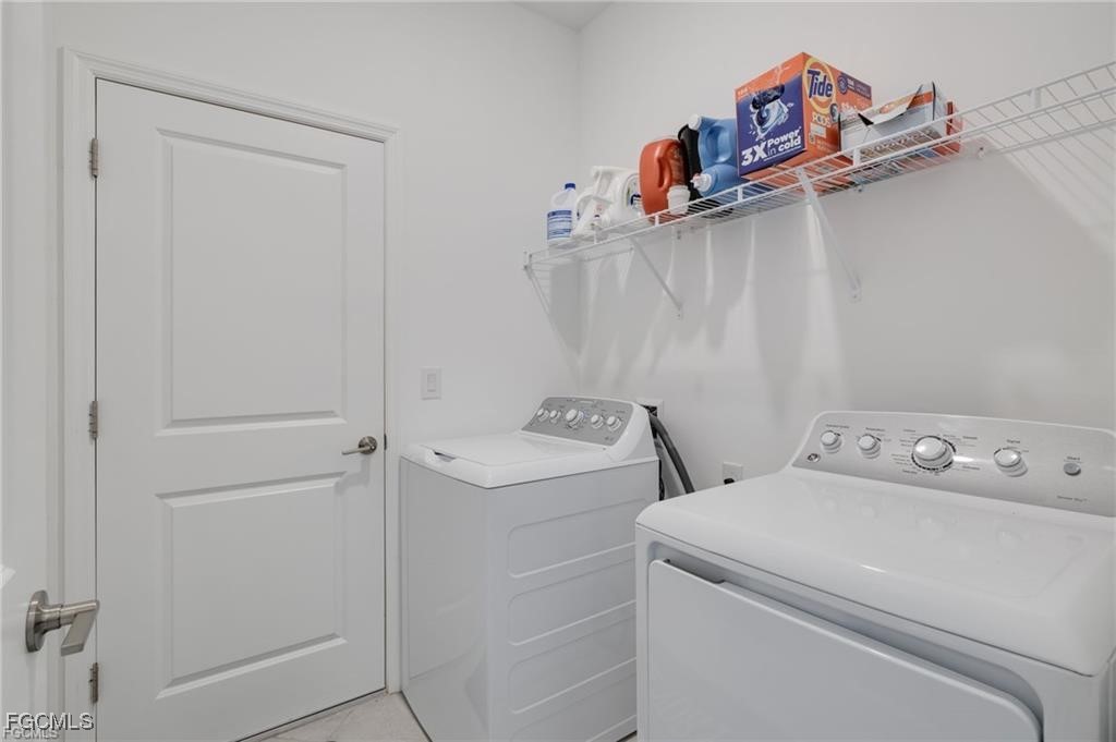 9146 Leatherwood Loop Lehigh Acres, FL 33936 - Photo 35 of 43 a utility room with dryer and washer