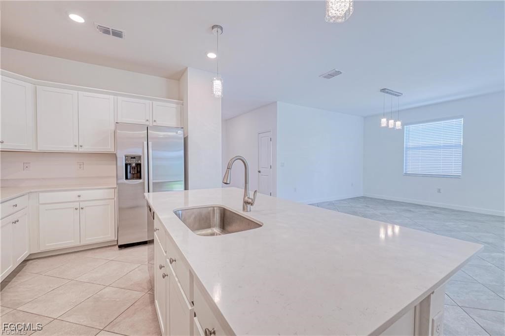 9146 Leatherwood Loop Lehigh Acres, FL 33936 - Photo 6 of 43 a kitchen that has a sink and a stove in it