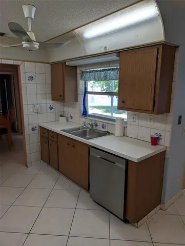 a kitchen with stainless steel appliances granite countertop a sink counter space cabinets and a large window