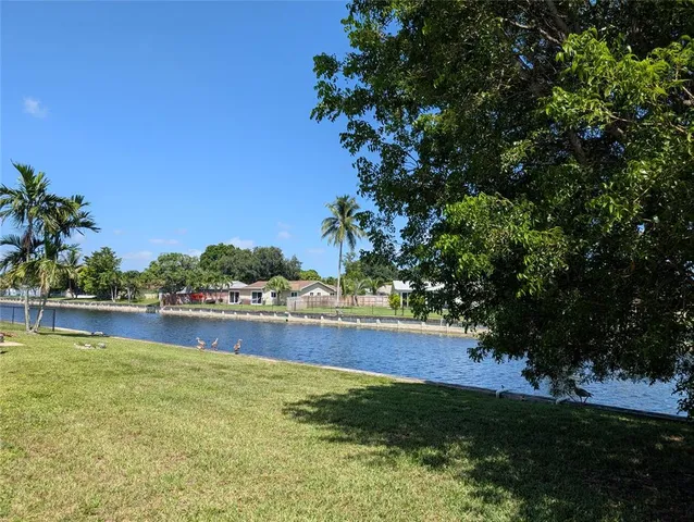 a view of a lake with houses in the back