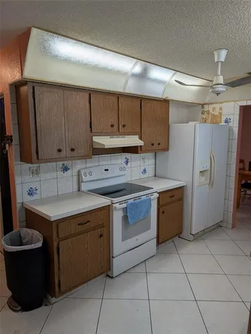 a kitchen with a cabinets and a stove top oven