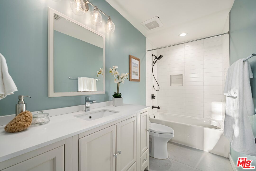 245 Main Street, Unit 314 Venice, CA 90291 - Photo 21 of 26 a bathroom with a double vanity sink toilet mirror and shower