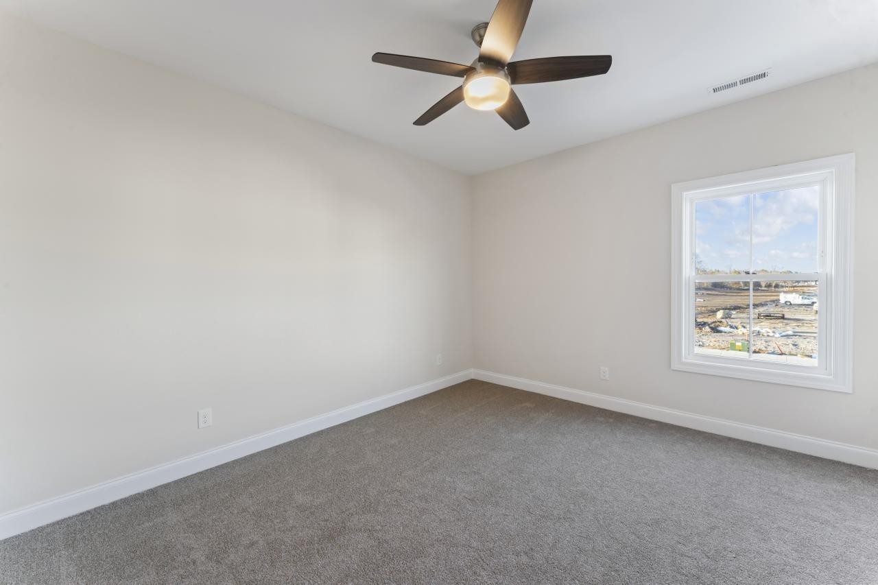 2128 Gracie Bug Loop Murfreesboro, TN 37128 - Photo 12 of 23 an empty room with a window and a fan