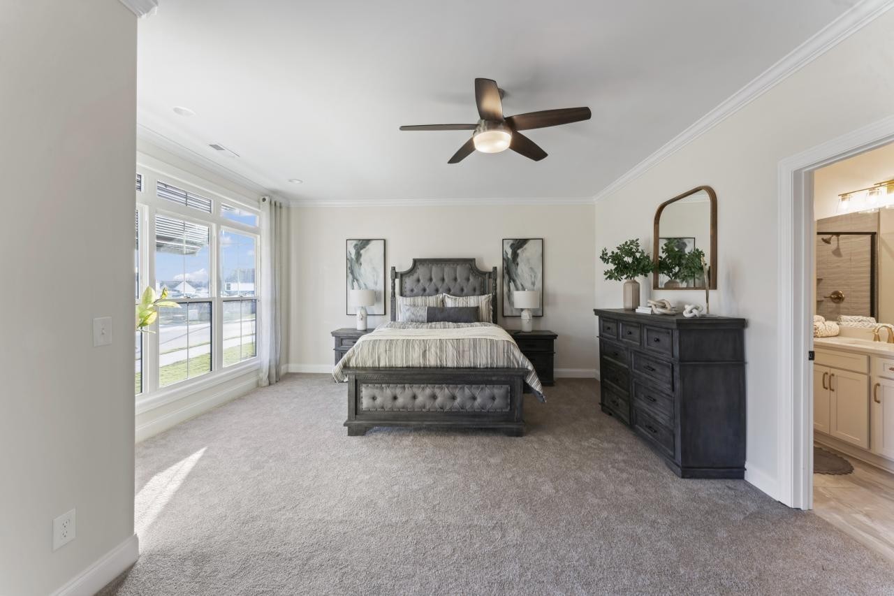 2128 Gracie Bug Loop Murfreesboro, TN 37128 - Photo 15 of 23 a spacious bedroom with a bed and a chandelier
