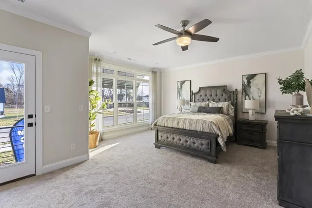 a spacious bedroom with a bed and a ceiling fan