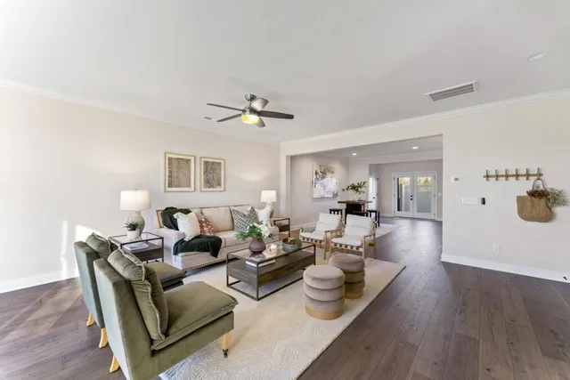 a living room with furniture and wooden floor