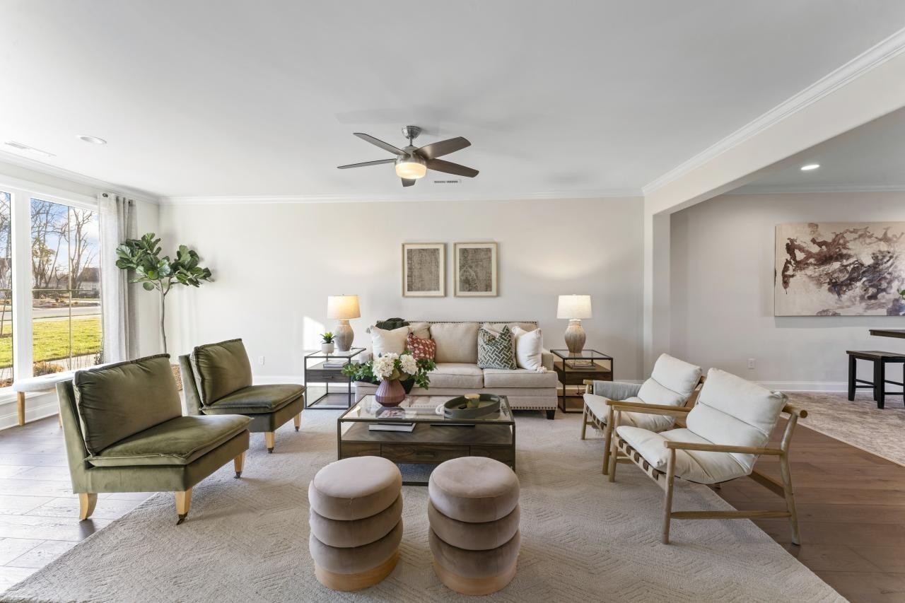 2128 Gracie Bug Loop Murfreesboro, TN 37128 - Photo 3 of 23 a living room with furniture a chandelier and a rug