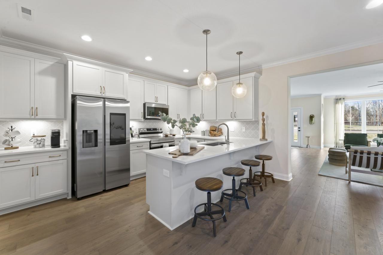 2128 Gracie Bug Loop Murfreesboro, TN 37128 - Photo 10 of 23 a kitchen with refrigerator a sink and chairs