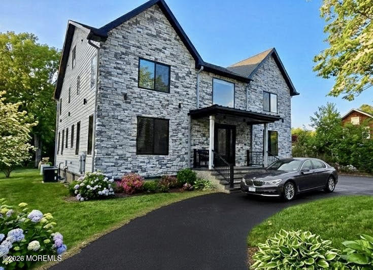 a car parked in front of a house with a garden