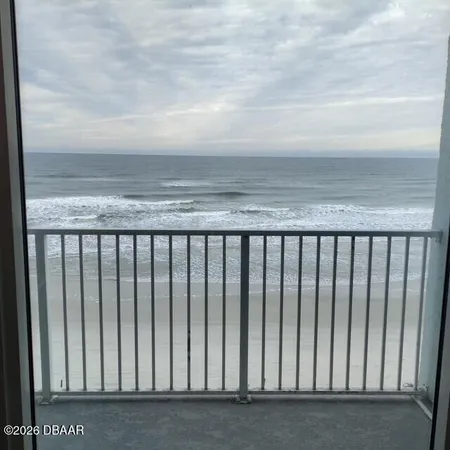 a kitchen with a refrigerator and white cabinets