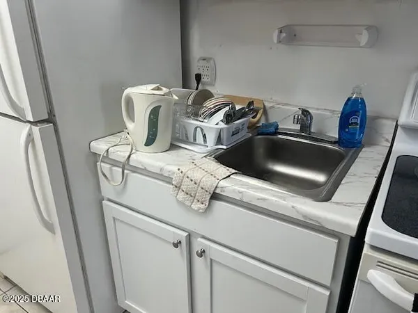 a close view of sink a washer and dryer