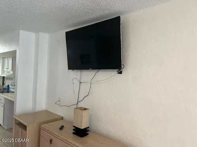 a living room with a flat screen tv and gym equipment