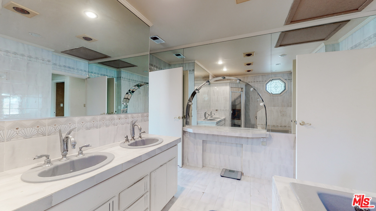 2254 Stradella Road Los Angeles, CA 90077 - Photo 18 of 29 a bathroom with a double vanity sink mirror and shower