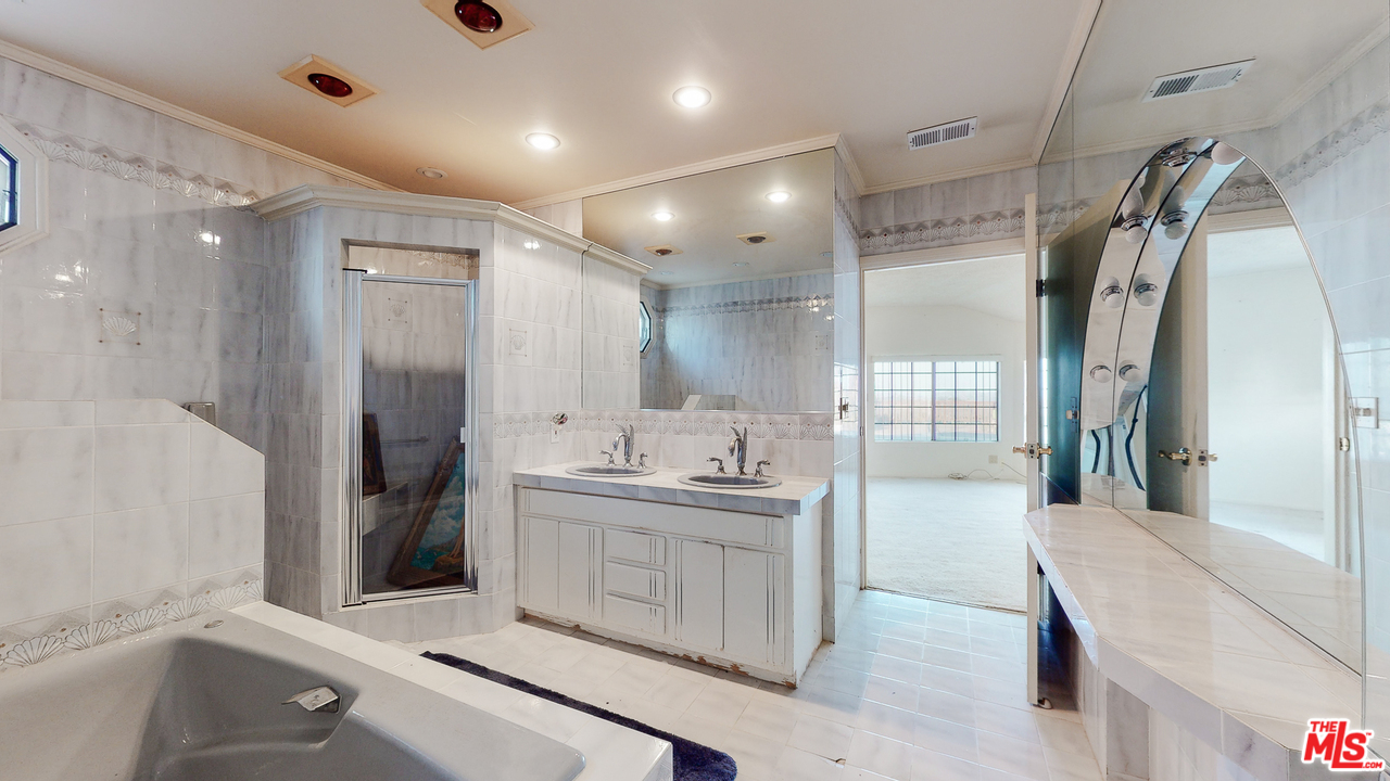 2254 Stradella Road Los Angeles, CA 90077 - Photo 19 of 29 a bathroom with a double vanity sink mirror and shower