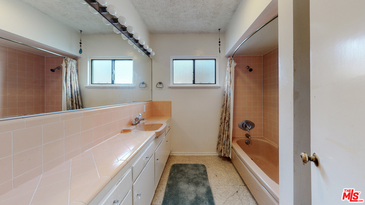 2254 Stradella Road Los Angeles, CA 90077 - Photo 21 of 29 a bathroom with a tub sink and mirror
