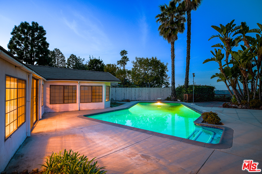 2254 Stradella Road Los Angeles, CA 90077 - Photo 27 of 29 a swimming pool with an outdoor space and seating area
