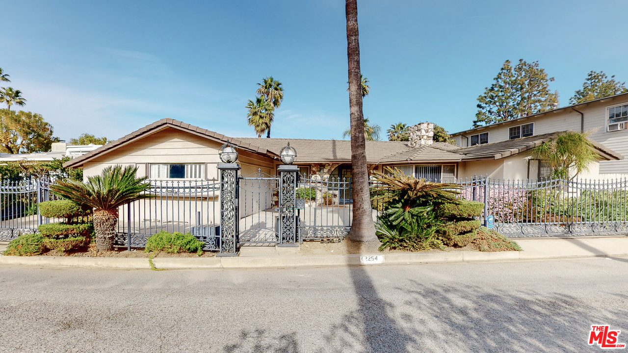 2254 Stradella Road Los Angeles, CA 90077 - Photo 9 of 29 a front view of a house with a garden