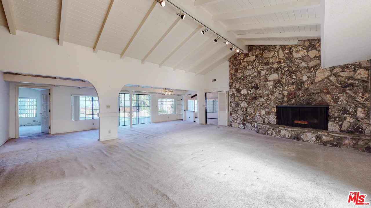 2254 Stradella Road Los Angeles, CA 90077 - Photo 10 of 29 a view of an empty room with a fireplace and a window