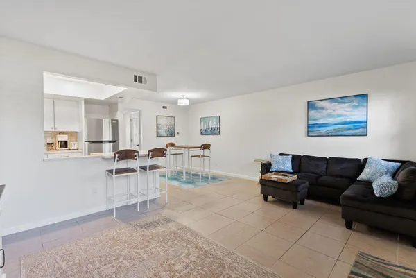 a kitchen with stainless steel appliances granite countertop a refrigerator and a stove top oven