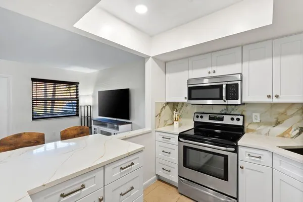 a kitchen with a refrigerator a sink and cabinets