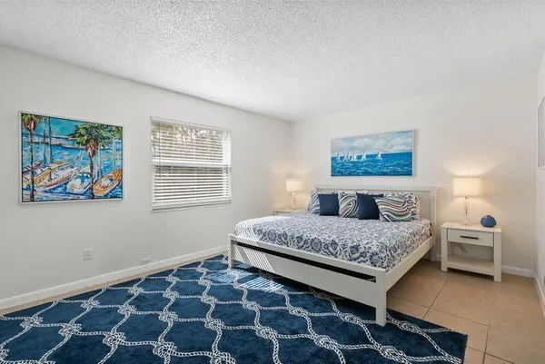 a bedroom with a bed and a painting on the wall