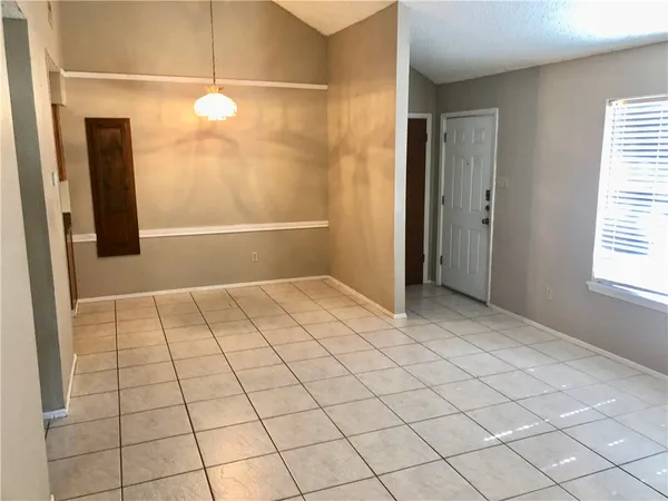 a kitchen with granite countertop a stove a sink and a refrigerator