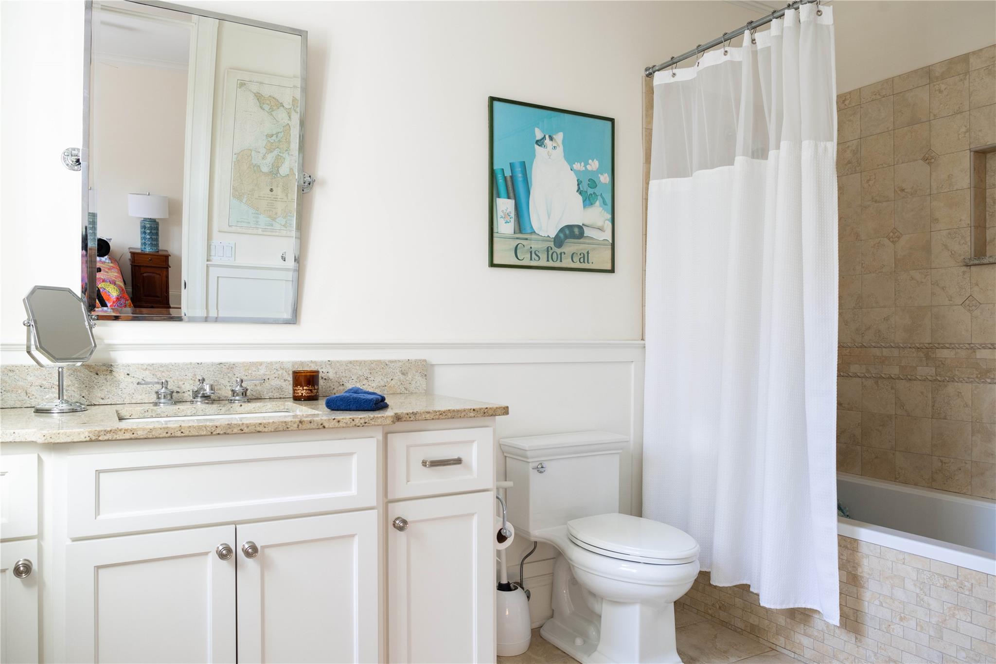 53 Cedar Lane West Remsenburg, NY 11960 - Photo 24 of 38 Bathroom featuring vanity, toilet, and tiled shower / bath combo